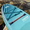 Close-up of a paddleboard resting on rocks near the water. Produktbild-Vorschau