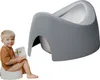 A young child is sitting on a potty training seat and holding a book. Náhľad obrázku produktu