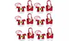 A collection of 12 Christmas-themed cutlery holders shaped like Santa's suit. Produktbild-Vorschau
