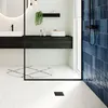 A modern bathroom with a sink, vanity, shower, and tiled walls and floor. Produktbild-Vorschau
