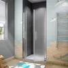 A bathroom with a shower enclosure, a towel rack, and a rug. Produktbild-Vorschau