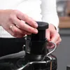 A person's hands are shown operating a black juicer. Produktbild-Vorschau
