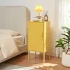 A yellow nightstand next to a bed, with a lamp and decor on top. Anteprima dell’immagine prodotto