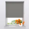 A gray roller blind is shown covering most of a window, with a vase of orange tulips on the windowsill below. Produktbild-Vorschau