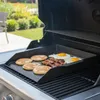 A griddle plate with pancakes, bacon, and eggs cooking on a grill. Podgląd zdjęcia produktu