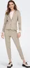 A woman is posing in a beige suit. Produktbild-Vorschau