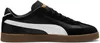 A side view of a black Puma sneaker with a white stripe and a brown sole. Voir les images du produit