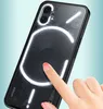 A hand is touching the back of a black smartphone with a transparent back and glowing white accents. Produktbild-Vorschau