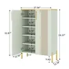 A light green shoe cabinet with gold accents and legs, shown with its doors open to reveal multiple shelves. Dimensions are indicated with measurement lines and text. Produktbild-Vorschau