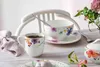 A table setting with a coffee mug, bowl, and sugar bowl, decorated with floral patterns. Podgląd zdjęcia produktu