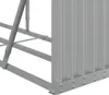 A close-up view of the corner of a grey metal firewood rack, showing the corrugated siding and the metal frame with rivets. Náhled obrázku produktu