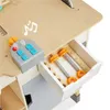 A close-up view of a wooden toy workbench, showing a control panel with buttons and a drawer containing toy screws and a ruler. Produktbild-Vorschau