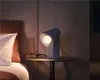 A bedside table with a lamp and glasses. Náhled obrázku produktu