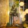 A decorated Christmas tree with gifts and a lantern in a cozy room setting. Anteprima dell’immagine prodotto