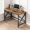 A rustic industrial-style computer desk with a wooden top and black metal legs, set up in a home office environment. Podgląd zdjęcia produktu