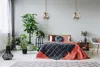 A bedroom scene with a bed, plants, and lighting. Produktbild-Vorschau