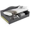 A gray upholstered daybed with storage compartments underneath, shown with bedding and folded blankets. Anteprima dell’immagine prodotto