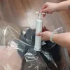 Hands using a manual pump to remove air from a vacuum storage bag containing clothes and bedding. Podgląd zdjęcia produktu