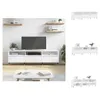 A white TV stand with a television on it, placed in a living room setting with shelves and a coffee table. Náhled obrázku produktu