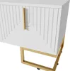 A close-up, angled view of the lower right corner of a white cabinet with a gold handle and gold metal legs. Produktbild-Vorschau