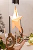 A decorated table setting with a star lamp, candles, and Christmas decorations. Náhled obrázku produktu