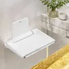 A white foldable shower seat mounted on a tiled wall. Produktbild-Vorschau