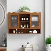 A wooden wall-mounted cabinet filled with various bathroom or cosmetic products. Produktbild-Vorschau