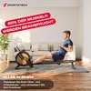 A man is using a rowing machine in a living room setting. Produktbild-Vorschau