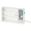 A close-up of a clear plastic battery pack for LED lights, showing the switch and timer settings. Produktbild-Vorschau