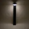 A black solar-powered outdoor light fixture mounted on a wall. Produktbild-Vorschau