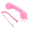 A pink retro telephone handset with a coiled cord and a 3.5mm jack connector, isolated on a white background. Náhľad obrázku produktu
