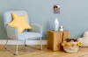 A child's room with a chair, side table, and basket. Anteprima dell’immagine prodotto
