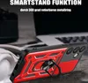 A close-up of a red and black phone case with a ring holder, placed on a textured surface with a blurred background of a laptop. Produktbild-Vorschau