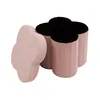 A pink clover-shaped storage ottoman with a black interior, shown from a slightly elevated side angle. Podgląd zdjęcia produktu