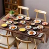 A table set with plates of food, bowls, and glasses, ready for a meal. Náhled obrázku produktu