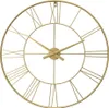 A close-up, front-facing shot of a gold-colored, metal wall clock with Roman numerals. Voir les images du produit
