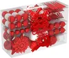 A clear, well-lit studio shot of a box filled with red and white Christmas ornaments, including various shapes and sizes, with a decorative reindeer and "Merry Christmas" text overlay. Náhľad obrázku produktu