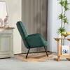 A dark green corduroy rocking chair is shown in a living room setting, next to a side table with a fruit bowl and a plant. Anteprima dell’immagine prodotto