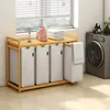 A laundry basket with multiple compartments next to a washing machine. Anteprima dell’immagine prodotto
