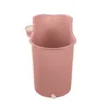 A pink bath bucket with a small basket attached to the side and a spout at the bottom. Náhled obrázku produktu