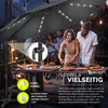 People enjoying a meal outdoors under a large umbrella with LED lights. Anteprima dell’immagine prodotto