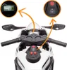 Close-up view of the handlebars and dashboard of a white electric motorcycle, with inset images highlighting the digital display and control buttons. Voir les images du produit