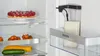 Inside a refrigerator, showing a tart, tomatoes, zucchini, and a milk container. Anteprima dell’immagine prodotto