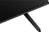 Close-up of the bottom right corner of a black television set, showing one of its black legs. Produktbild-Vorschau