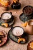 A coffee set with cups, saucers, coffee beans, croissants, and pastries on a textured surface. Podgląd zdjęcia produktu