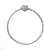 A silver Pandora Moments bracelet with a heart-shaped charm encrusted with small stones, isolated on a white background. Anteprima dell’immagine prodotto