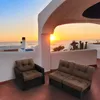 A patio with two outdoor cushions and a sunset view over the ocean. Náhled obrázku produktu