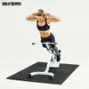 A woman is using a hyperextension bench in a gym setting. Produktbild-Vorschau