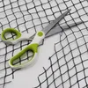 A black net is being cut by a pair of scissors with green and white handles. Podgląd zdjęcia produktu