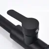 A close-up view of a black faucet handle and part of the spout. Produktbild-Vorschau